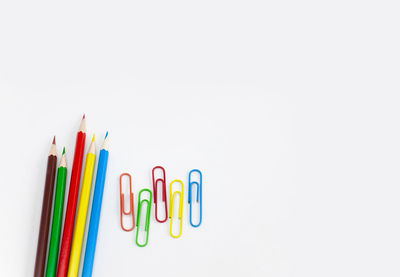 Close-up of multi colored pencils against white background