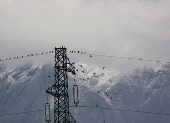 Low angle view of snow covered mountain against sky