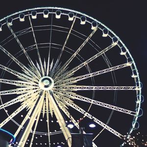 Low angle view of ferris wheel against sky