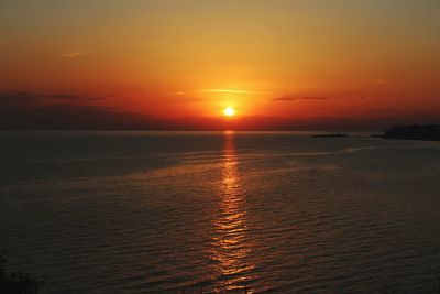 Scenic view of sea against romantic sky at sunset
