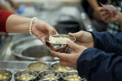 Cropped hands holding bowls