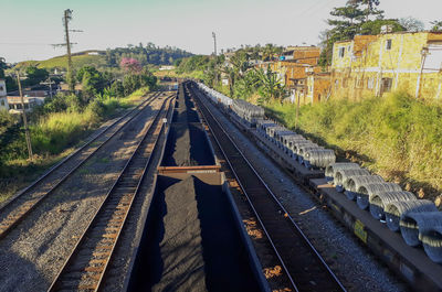 Railroad tracks amidst trees against sky