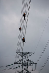 Low angle view of cables against sky