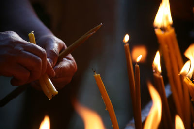 Close-up of lit candles in the dark