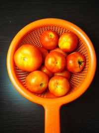 High angle view of oranges in basket on table