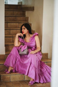 Young woman sitting on sofa at home