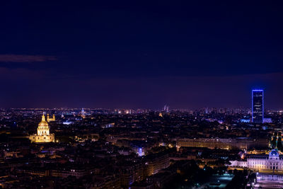 High angle view of city lit up at night