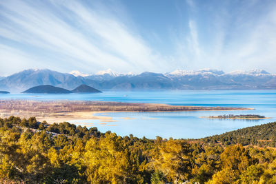 Scenic view of lake and mountains against sky