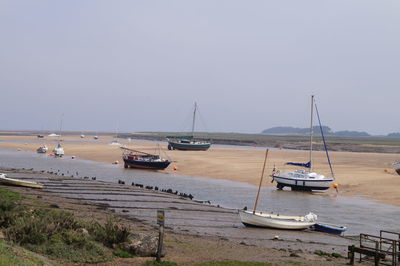 Sailboats moored in marina