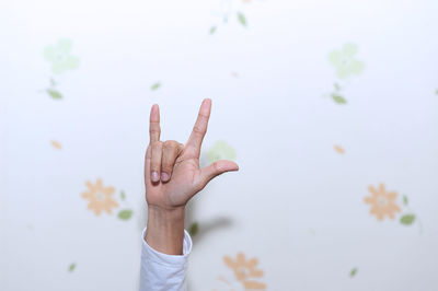 Close-up of man hand gesturing against wall