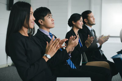 Business people applauding during presentation