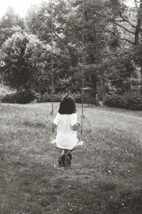 Rear view of girl standing in park