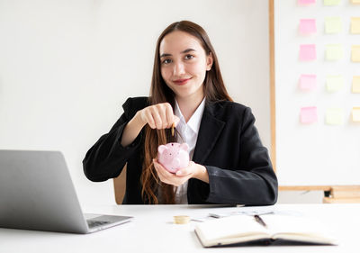 Portrait of young businesswoman working at table