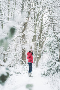 Full length of woman standing on snow covered land