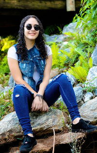 Portrait of young woman sitting outdoors