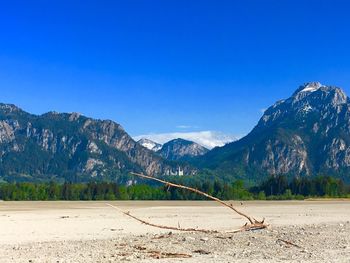 Scenic view of mountains against blue sky