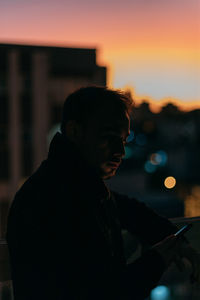 Rear view of man standing against wall