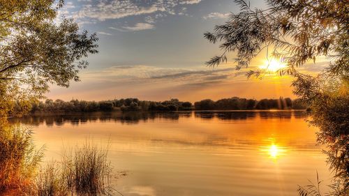 Scenic view of lake against sky during sunset