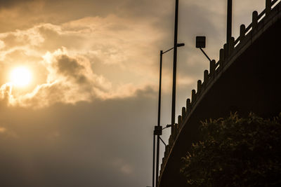 Low angle view of bridge against sky at sunset