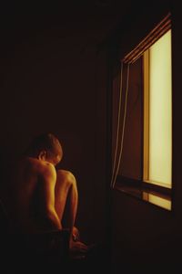 Man looking at window at home