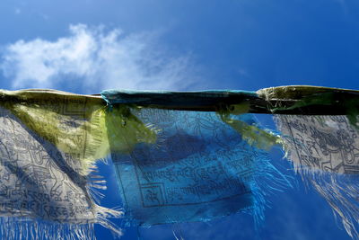 Closeup of designed fabrics against cloudy sky