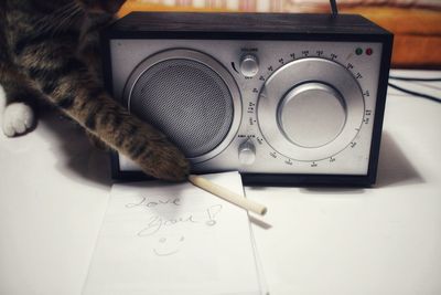 Close-up of love message near a radio and a cat on table