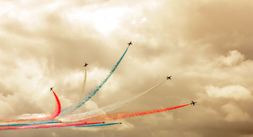 Low angle view of airplane flying against sky