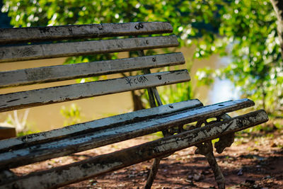 Close-up of empty bench in park