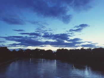 Scenic view of lake against sky at sunset
