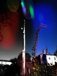 Low angle view of illuminated building against sky at night