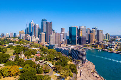 Panoramic view of city buildings against clear blue sky