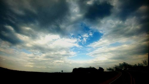 Low angle view of silhouette trees against sky