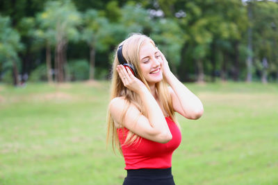 Young woman smiling while standing on land
