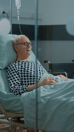 Mid adult man sitting on bed