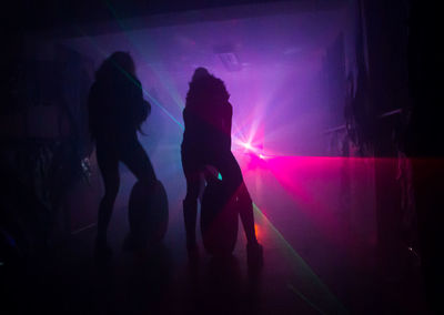 Silhouette people dancing at nightclub