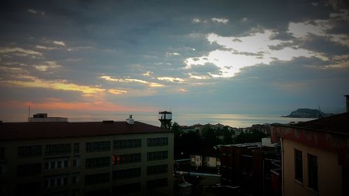 Buildings in city at sunset