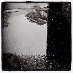 Reflection of buildings in puddle