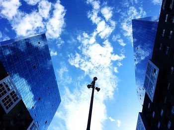 Low angle view of skyscrapers against blue sky