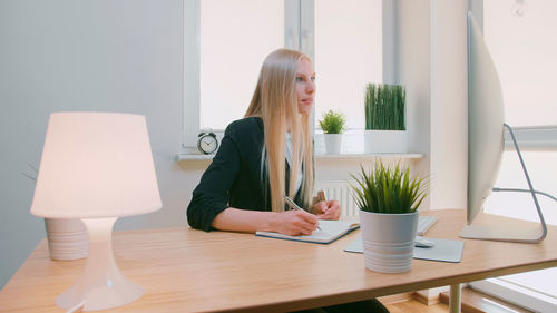 Young woman using laptop on table