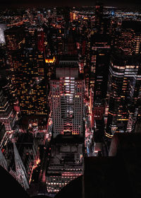 High angle view of illuminated city buildings at night