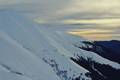 Scenic view of snow covered mountains against sky