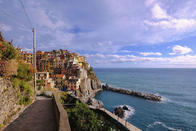 Panoramic view of sea and buildings against sky