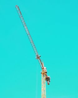 Low angle view of windmill against clear blue sky