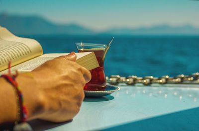 Midsection of woman preparing food on table at beach