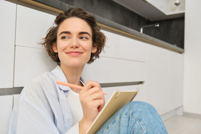 Portrait of young woman using mobile phone