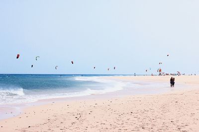 View of people kite surfing on beach