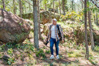Rear view of woman walking in forest