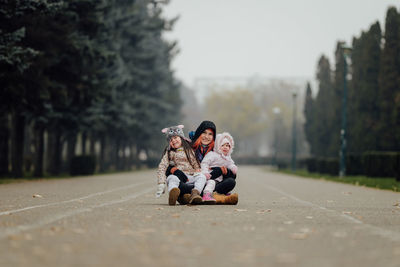 Happy mother with two daughters in the park