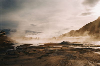 Scenic view of steam emitting from volcanic landscape