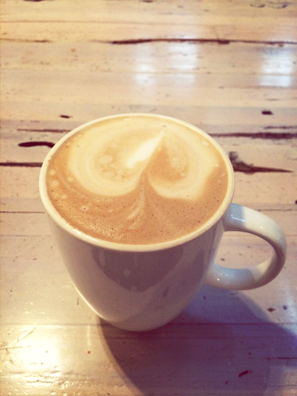 drink, refreshment, coffee cup, coffee - drink, frothy drink, food and drink, saucer, table, coffee, cappuccino, froth art, indoors, freshness, close-up, high angle view, still life, latte, cup, wood - material, no people